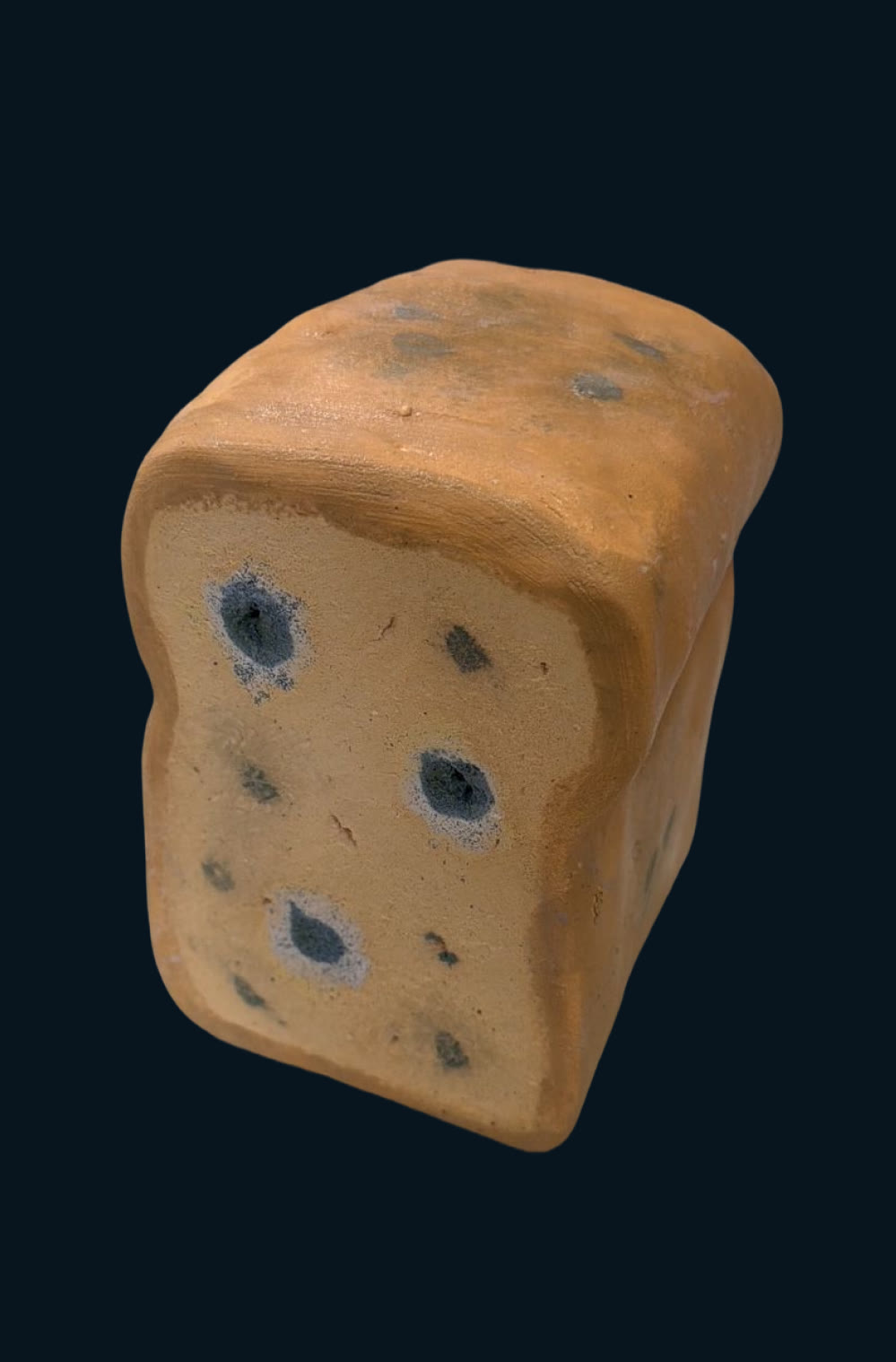 Ceramic loaf of bread with blue mould spots